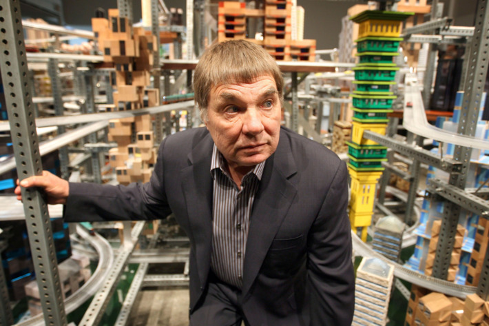 12 Jan 2012, Los Angeles, California, USA --- Chris Burden stands next to his large-scale kinetic sculpture, Metropolis II, during the media preview at the Los Angeles County Museum of Art (LACMA) in Los Angeles, California January 11, 2012. The sculpture, modeled after a fast-paced futuristic city with 1,100 miniature cars running through an elaborate system of roadway tracks at a scale speed of about 240 miles per hour (386 kph), is meant to evoke the energy of a city. The exhibit opens to the public January 14. REUTERS/David McNew (UNITED STATES - Tags: TRANSPORT SOCIETY) --- Image by ? DAVID MCNEW/Reuters/Corbis