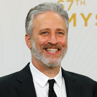 Jon Stewart holds his awards during the 67th Primetime Emmy Awards in Los Angeles