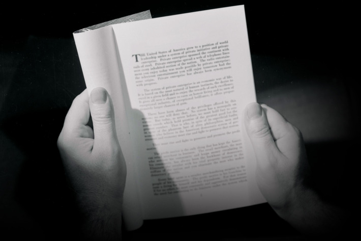 Hands Holding Open Booklet