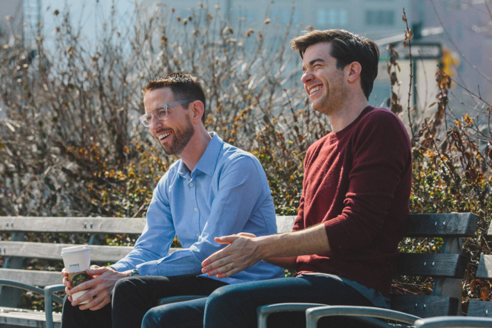 Comedians Neal Brennan, left, and John Mulaney, right, sit on a park bench in Tribeca on March 9th, 2016. Brennan is currently doing a solo show called