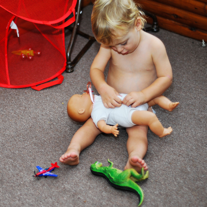 Baby with a doll.