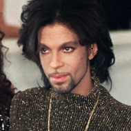 Prince poses for photographers with his wife Mayte
