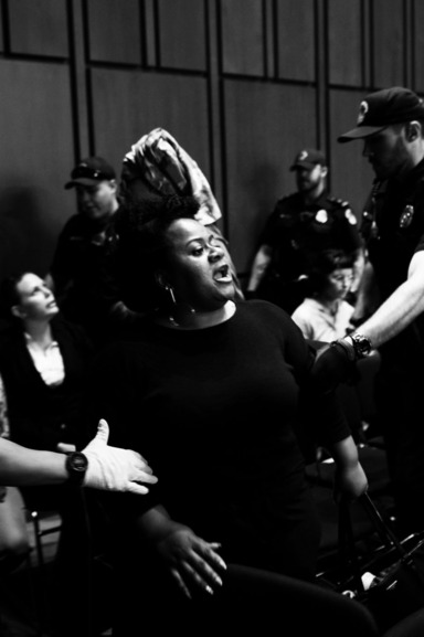 Protester thrown out of Kavanaugh hearings.