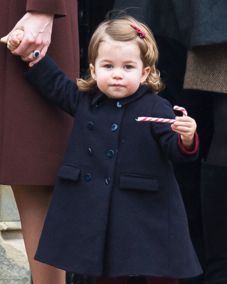 Princess Charlotte with a holiday snack (a candy cane).